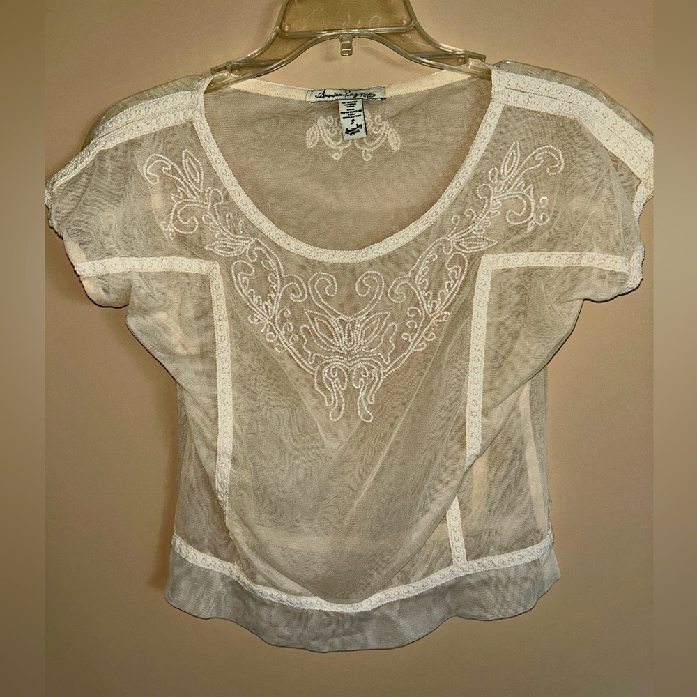 Cute see-through top with beaded details in a creamy/very light apricot color S